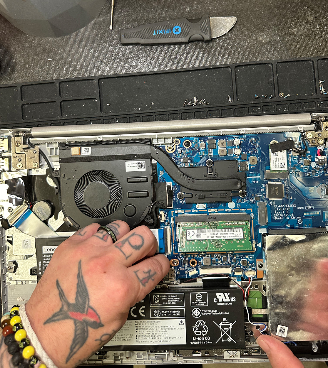 close-up of a gentleman repairing a computer